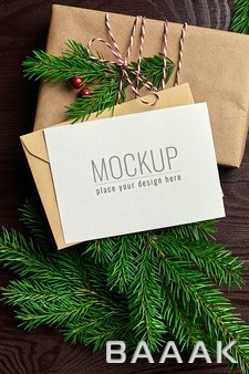 موکاپ-کارت-تبریک-کریسمس-با-دکور-هدایا-و-شاخه-های-درخت-صنوبر_409305603
